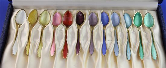 A cased set of twelve 20th century Norwegian sterling silver gilt and polychrome enamel coffee spoons by Hestenes, 3.75in.